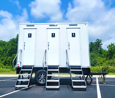 An exterior view of a Lang 3 Station Eco Series Restroom Trailer